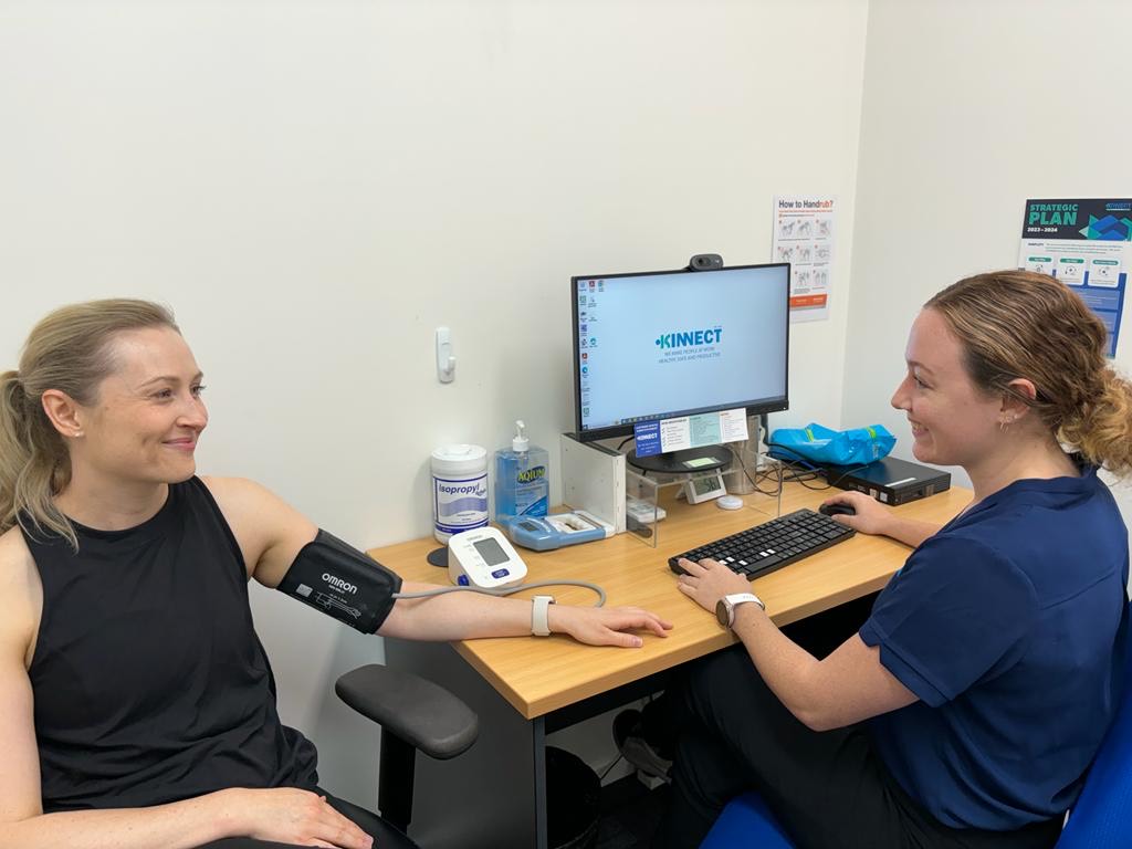 A KINNECT clinician taking a client's blood pressure during a consultation at our Cairns clinic